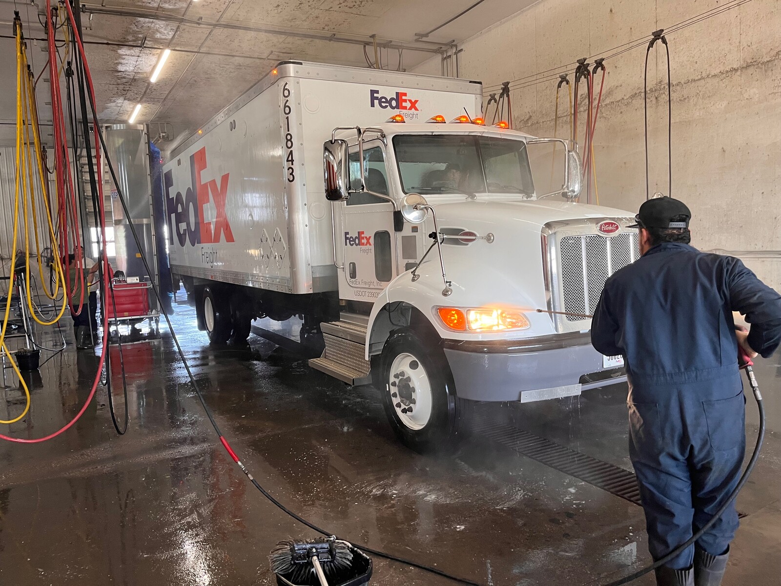 Inside of washbay with Fedex truck being washed